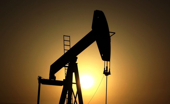 FILE- In this Wednesday, June 8, 2011 file photo, sun sets behind an oil pump in the desert oil fields of Sakhir, Bahrain. OPEC nations have agreed in theory that they need to reduce their production  ...