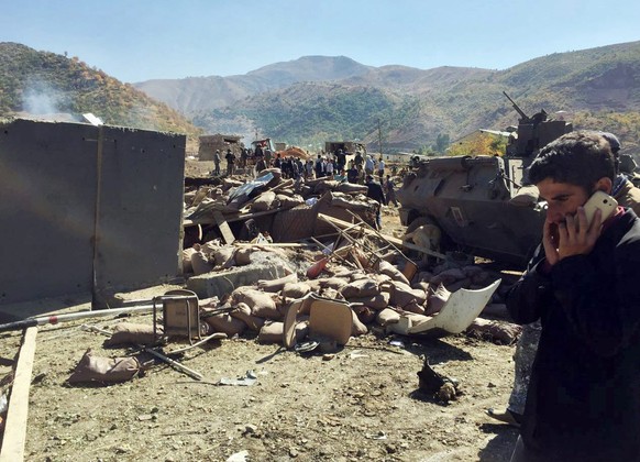 epa05578064 A picture taken by a smart phone shows Turkish soldiers and people try to help victims after a bomb attack to a military post near Iraqi border near Durak, near Semdinli, Hakkari province, ...