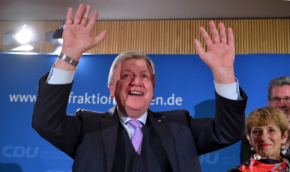 epa07127346 Prime Minister of Hesse, Volker Bouffier (L) of the Christian Democratic Union (CDU) party, waves to his supporters next to his wife Ursula Bouffier during the Hesse state elections in Wie ...