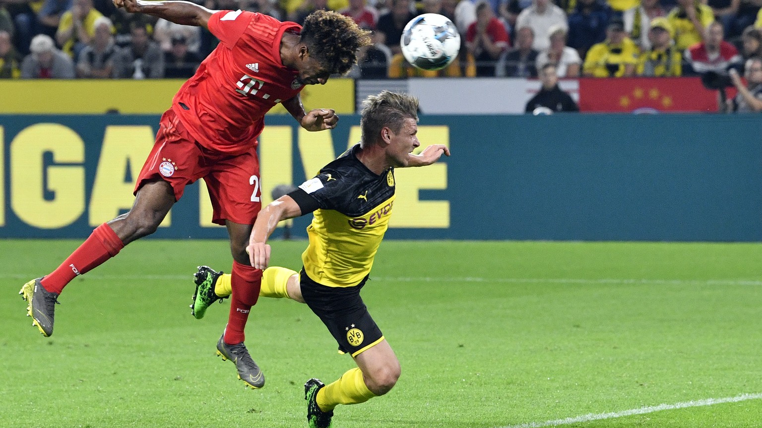 Bayern&#039;s Kingsley Coman, left, duels for the ball with Dortmund&#039;s Lukasz Piszczek during the German Supercup final soccer match between Borussia Dortmund and Bayern Munich in Dortmund, Germa ...