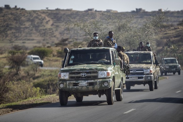 FILE - In this Saturday, May 8, 2021 file photo, Ethiopian government soldiers ride in the back of trucks on a road near Agula, north of Mekele, in the Tigray region of northern Ethiopia. Tigray force ...
