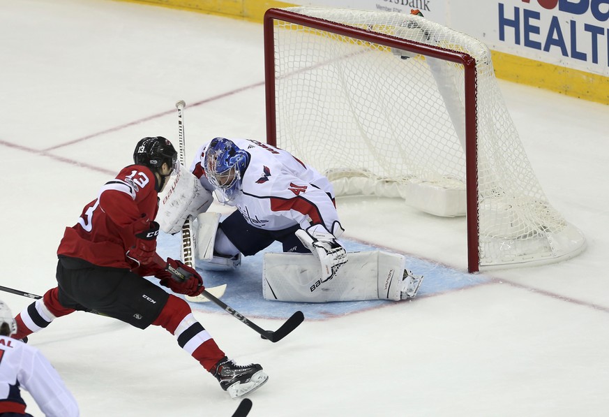 New Jersey Devils center Nico Hischier (13) of Switzerland, moves in for a score goal against Washington Capitals goalie Vitek Vanecek (41), of Czech Republic, during the third period of a preseason N ...