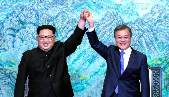 FILE - In this April 27, 2018, file photo, North Korean leader Kim Jong Un, left, and South Korean President Moon Jae-in raise their hands after signing a joint statement at the border village of Panm ...