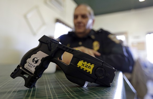 FILE - In this Nov. 14, 2013, file photo, a Taser X26 sits on a table in Knightstown, Ind. In the recent shootings of unarmed black men in a San Diego suburb and in Tulsa, Oklahoma, the police officer ...