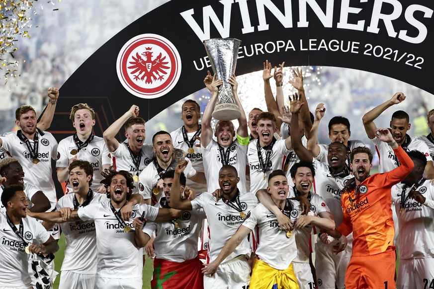 Frankfurt players lift the trophy for winners of the Europa League final soccer match between Eintracht Frankfurt and Rangers FC at the Ramon Sanchez Pizjuan stadium in Seville, Spain, Thursday, May 1 ...