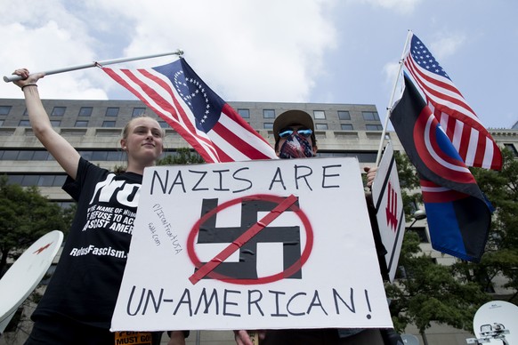 epa06946478 People gather on Freedom Plaza to join a counterprotest to the Unite the Right rally in Washington, DC, USA, 12 August 2018. Unite the Right are holding a rally in Washington, DC on the on ...