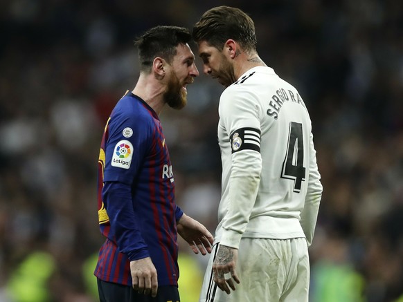 FILE - In this March 2, 2019 file photo, Barcelona forward Lionel Messi, left, goes head to head with Real defender Sergio Ramos as they argue during the Spanish La Liga soccer match between Real Madr ...
