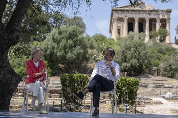 epa09278967 Greek Prime Minister Kyriakos Mitsotakis (R) listens to the European Commission President Ursula von der Leyen (L) speaking at the Ancient Agora of Athens, Greece, 17 June 2021. EPA/Petros ...