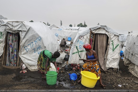epa11873330 Internally Displaced Persons sit outside their makeshift shelters at Lushagala camp in Goma, Democratic Republic of the Congo, 03 February 2025. Lushagala Kashaka IDP camp, which hosts abo ...