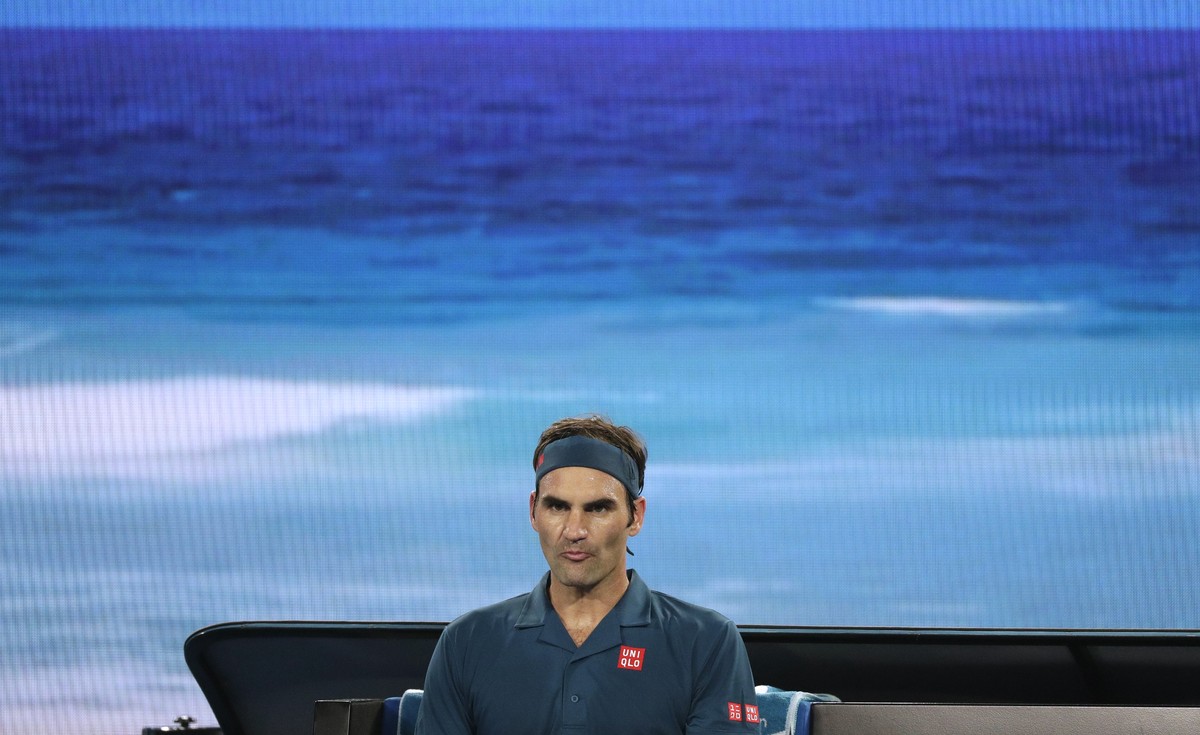 Switzerland's Roger Federer waits in his chair during a break in his third round match against United States' Taylor Fritz at the Australian Open tennis championships in Melbourne, Australia ...