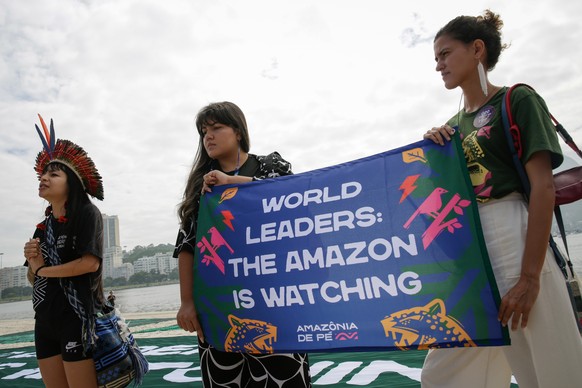 epa11725951 The Indigenous leader of the Paiter-Surui people, Txai Surui (L), participates with other activists in a rally in defense of the Amazon at the cove of Botafogo in Rio de Janeiro, Brazil, 1 ...