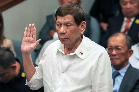 FILE - Former Philippine President Rodrigo Duterte takes oath during a senate inquiry on the so-called war on drugs during his administration at the Philippine Senate, on Oct. 28, 2024, in Manila, Phi ...