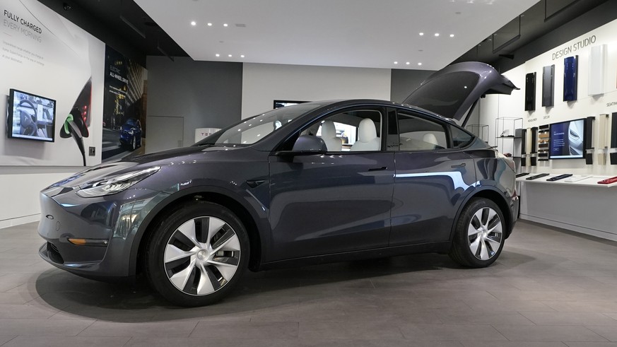 FILE - A Tesla Model Y Long Range is displayed on Feb. 24, 2021, at the Tesla Gallery in Troy, Mich. Tesla has raised prices on its Model Y in the U.S., apparently due to rising demand and changes in  ...