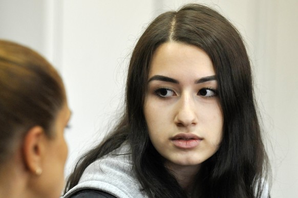 In this photo taken on Wednesday, June 26, 2019, Krestina Khachaturyan attends hearings in a court room in Moscow, Russia. Three Khachaturyan sisters, now aged 18, 19 and 20, face charges of the preme ...
