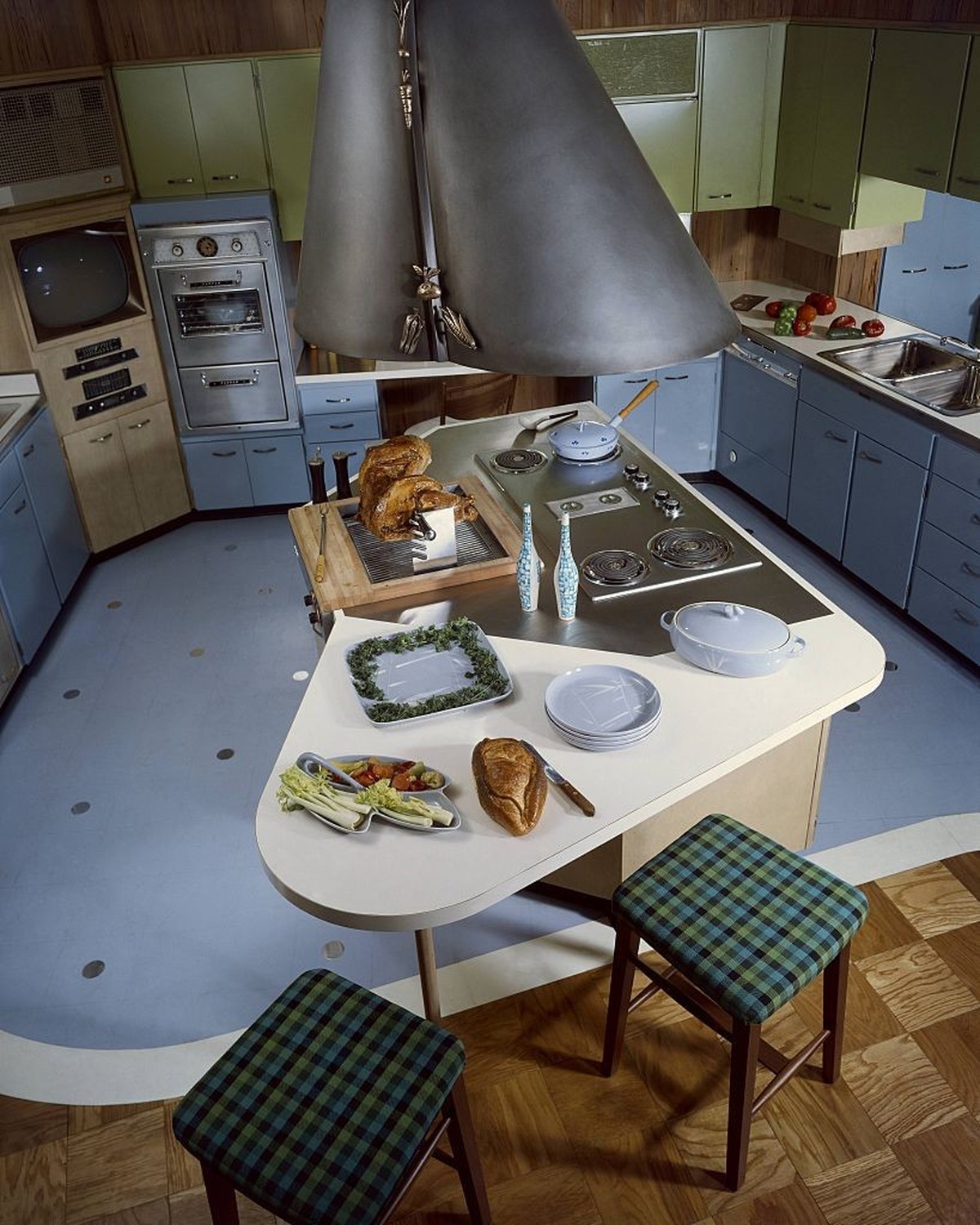 UNITED STATES - AUGUST 01 1958: 12 new idea kitchens: Powder Blue cabinets and floor surround a Modernist center island cooktop and barbecue in this model kitchen by designers Ralph &amp; Jane Bonnell ...