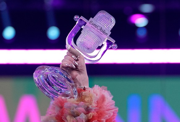 FILE - Nemo of Switzerland, who performed the song The Code, celebrates holding the trophy after winning the Grand Final of the Eurovision Song Contest in Malmo, Sweden, Sunday, May 12, 2024. (AP Phot ...