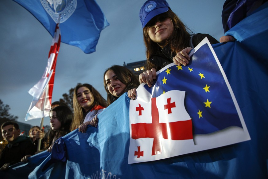 epa11031265 People celebrate during a rally after Georgia was granted the status of official candidate for entry into the European Union, in central Tbilisi, Georgia, December 15, 2023. The Council...