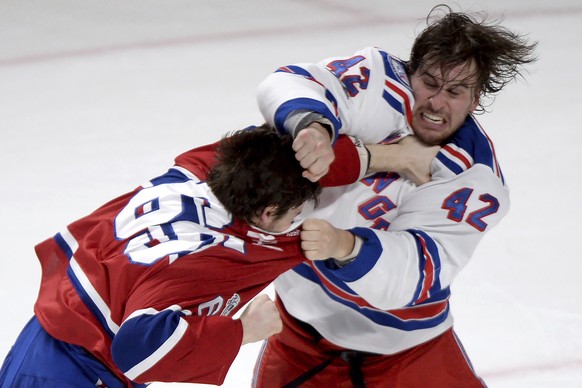 New York Rangers defenseman Brendan Smith (42) and Montreal Canadiens center Andrew Shaw (65) fight during the first period of Game 5 of a first-round NHL hockey Stanley Cup playoff series, Thursday,  ...