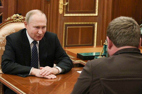 Russian President Vladimir Putin listens to Chechnya&#039;s regional leader Ramzan Kadyrov, back to a camera, during their meeting at the Kremlin in Moscow, Russia, Monday, March 13, 2023. (Mikhail Kl ...