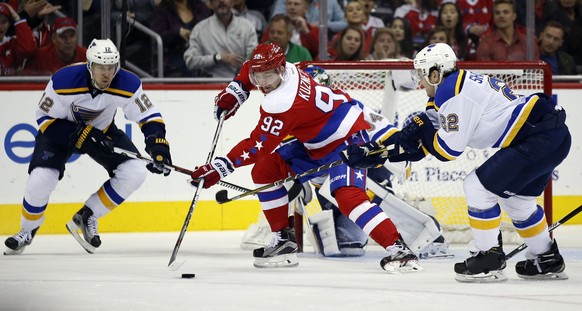 Washington Capitals center Evgeny Kuznetsov (92), from Russia, works the puck with St. Louis Blues center Jori Lehtera (12), from Finland, and defenseman Kevin Shattenkirk (22) defending in the second ...