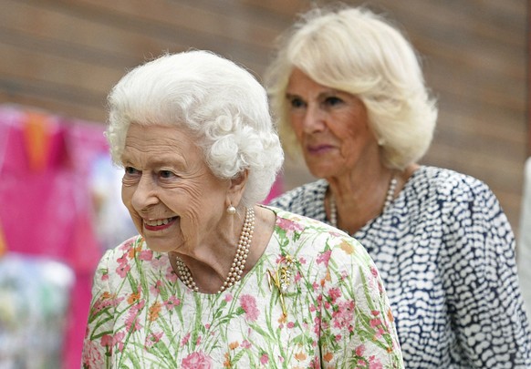 FILE - Britain&#039;s Queen Elizabeth II, foreground and Camilla, the Duchess of Cornwall attend an event in celebration of &#039;The Big Lunch &#039;initiative, during the G7 summit in Cornwall, Engl ...