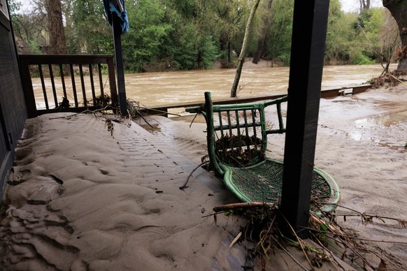 epa10405992 Debris and mud left by flood waters from the San Lorenzo Creek over flowed its banks in Felton, California, USA, 14 January 2023. California Governor Gavin Newsom proclaimed a state of eme ...