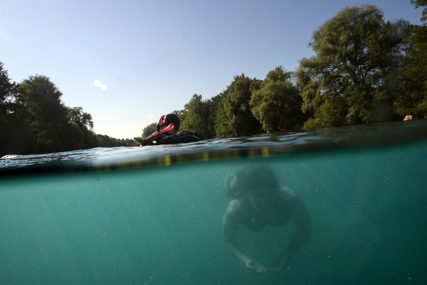 Stefanie swims in the Aare River between Thun and Bern, Switzerland, this Sunday, July 1, 2018. (KEYSTONE/Anthony Anex)