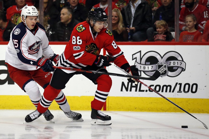 Chicago Blackhawks right wing Patrick Kane, right, controls the puck against Columbus Blue Jackets defenseman Markus Nutivaara during the first period of an NHL hockey game Friday, March 31, 2017, in  ...