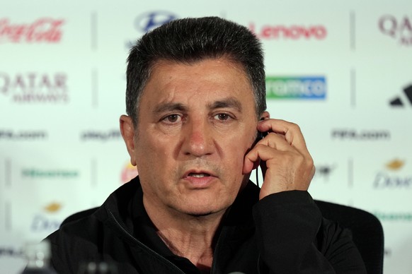 Iran head coach Amir Ghalenoei listens to a question during a press conference ahead of a FIFA World Cup match against Belgium in Inglewood, Calif., near Los Angeles, Saturday, June 20, 2026. (AP Phot ...