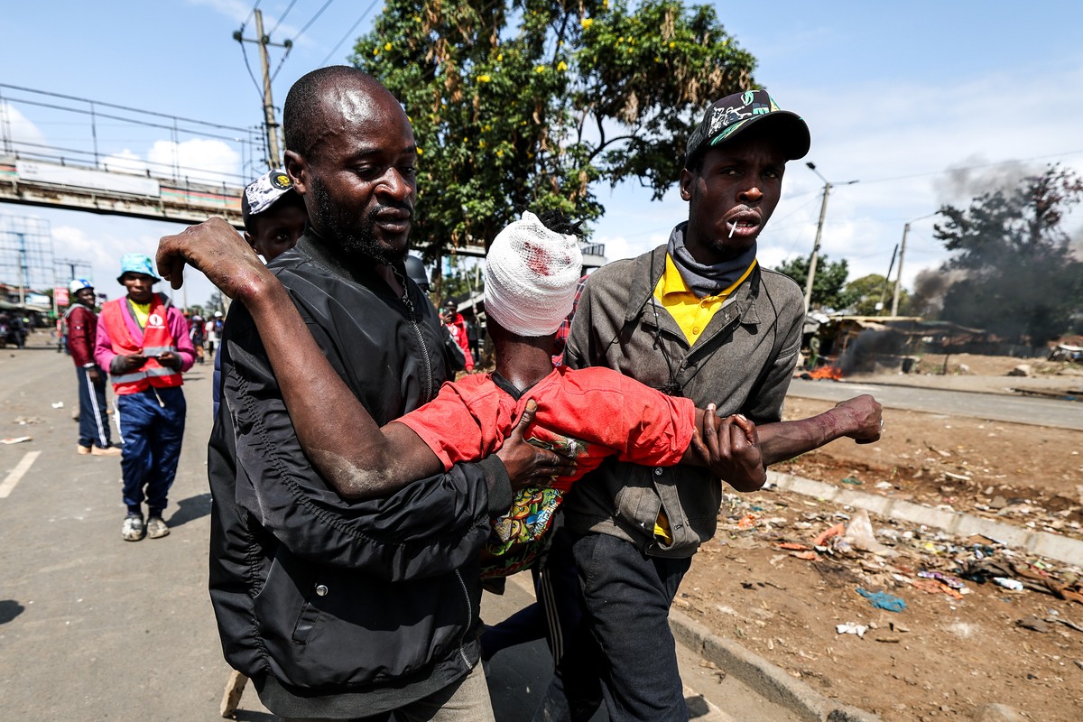 KEYPIX - epa12222560 An injured protester is assisted after being shot with a rubber bullet by anti-riot police during anti-government protests on Saba Saba day (or Seven-Seven in Swahili language) in ...