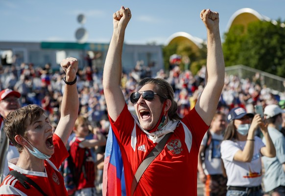 epa09276498 Russian soccer fans cheer at the Fan Zone while watching the UEFA EURO 2020 group B preliminary round soccer match between Finland and Russia in Moscow, Russia, 16 June 2021. EPA/YURI KOCH ...