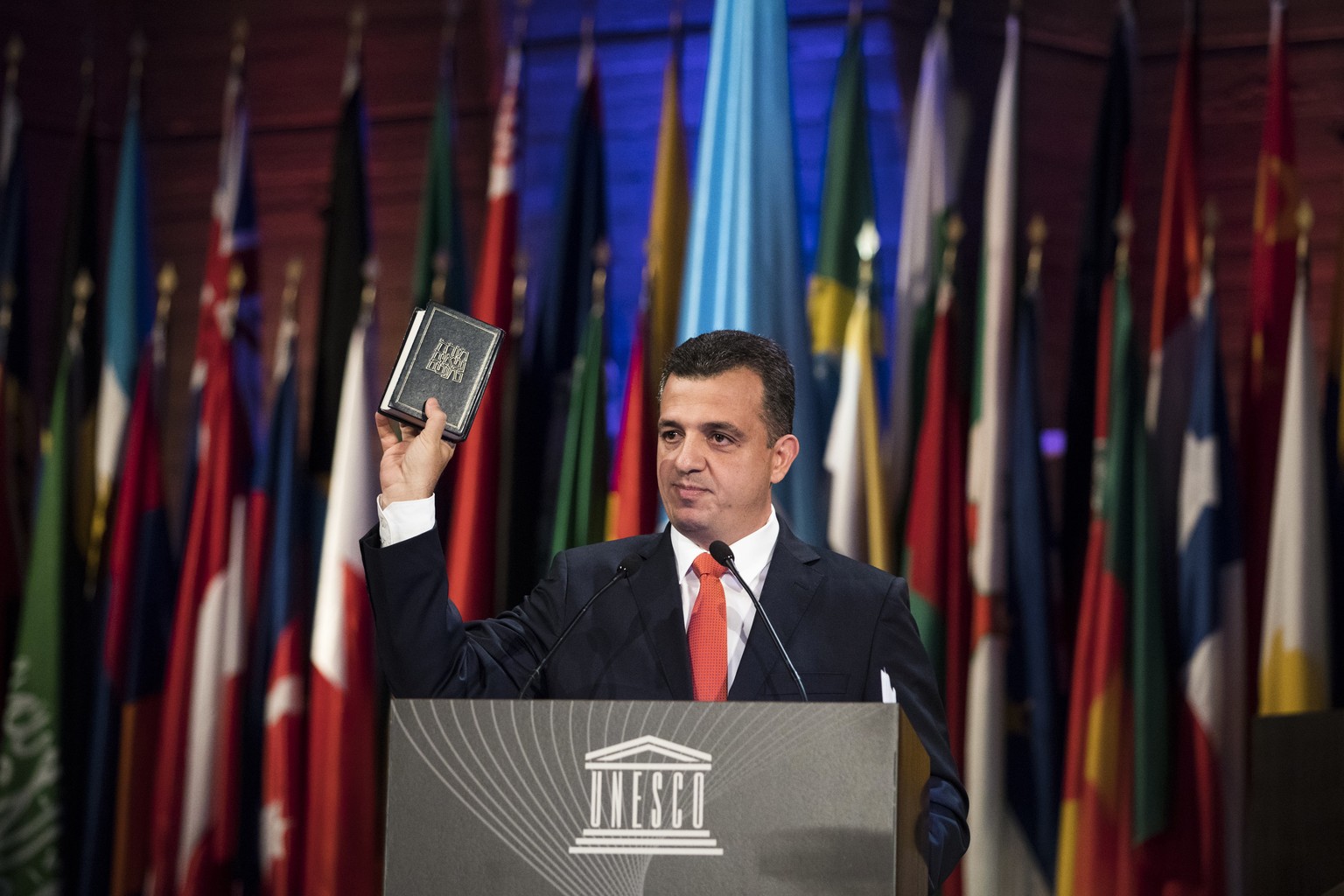 Israeli UNESCO ambassador Carmel Shama Hacohen displays a Bible as he addresses the 39th session of the General Conference at the United Nations Educational, Scientific and Cultural Organisation, UNES ...