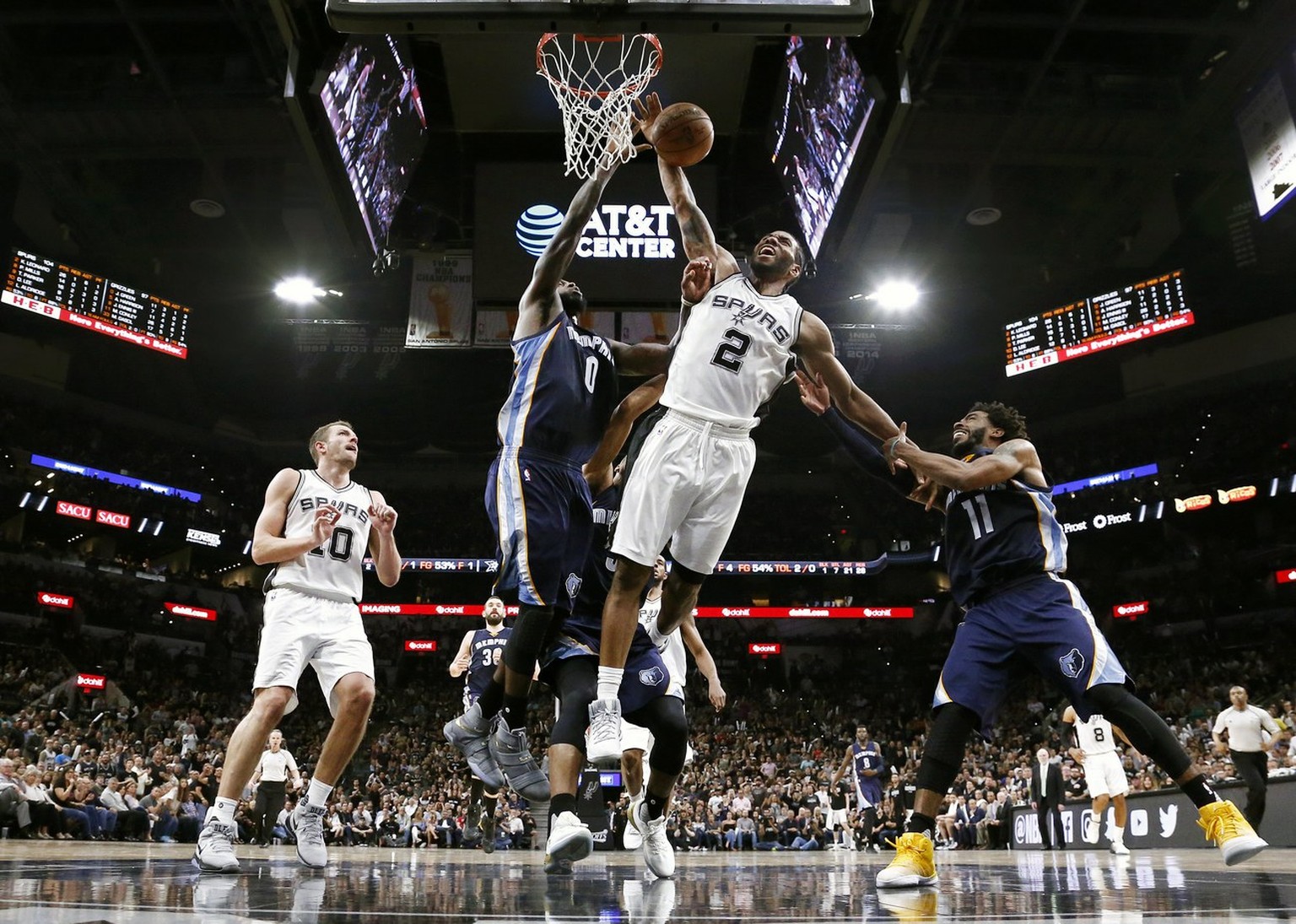 epa06255965 YEARENDER 2017 APRIL.Memphis Grizzlies players Mike Conley (R) and JaMychal Green (2-L) commit a foul against San Antonio Spurs forward Kawhi Leonard (C) in the second half of the NBA West ...