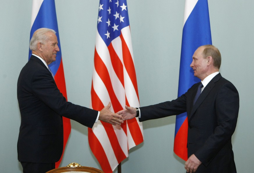FILE - In this March 10, 2011, file photo, Vice President of the United States Joe Biden, left, shakes hands with Russian Prime Minister Vladimir Putin in Moscow, Russia. Putin won