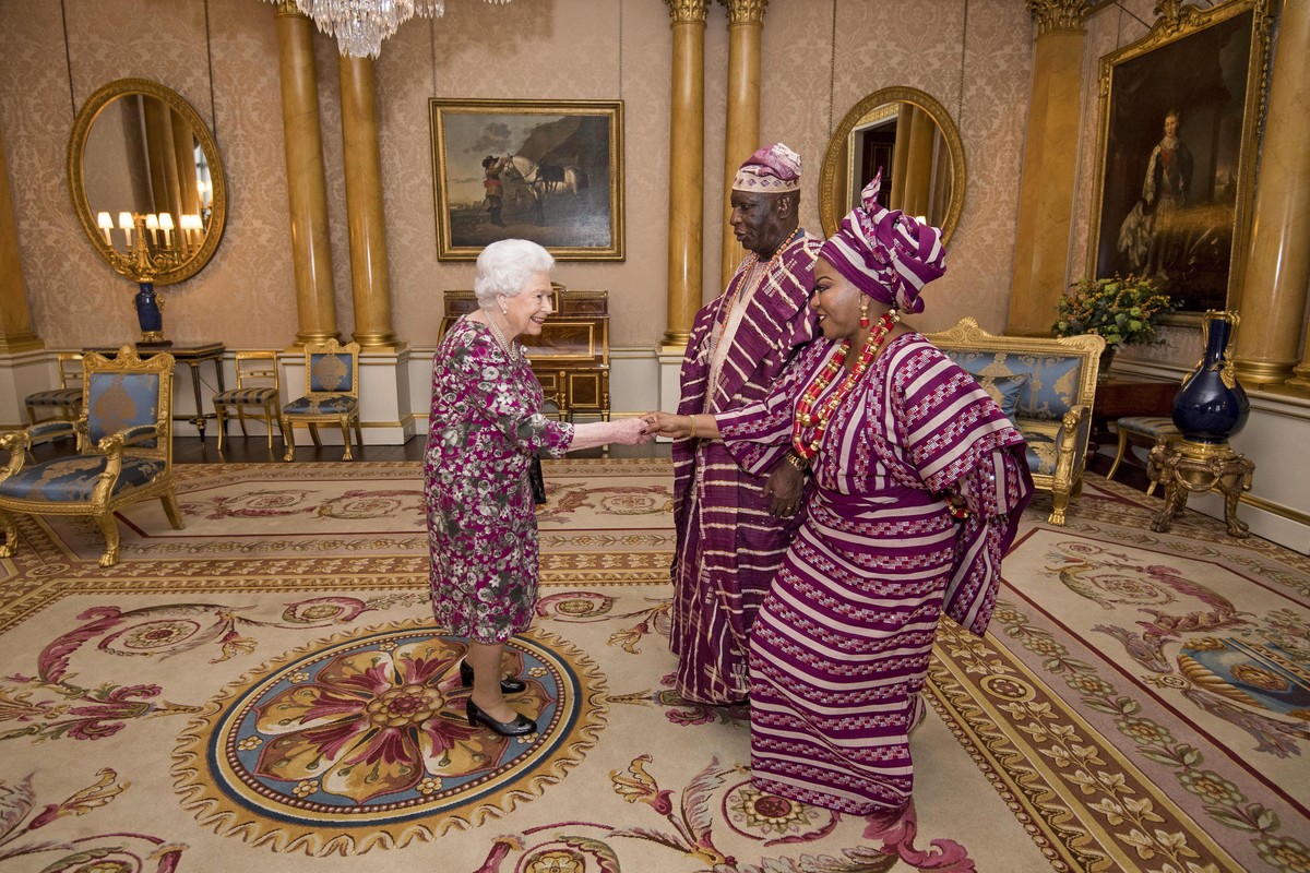 Britain's Queen Elizabeth II meets Mr George Adesola Oguntade, the High Commissioner of the Federal Republic of Nigeria, as he presents his Letter of Credence with his wife Mrs Oguntade during a  ...