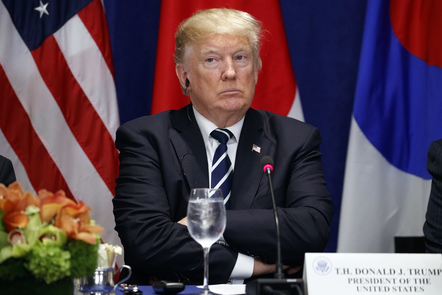 President Donald Trump listens during a luncheon with South Korean President Moon Jae-in and Japanese Prime Minister Shinzo Abe, at the Palace Hotel during the United Nations General Assembly, Thursda ...