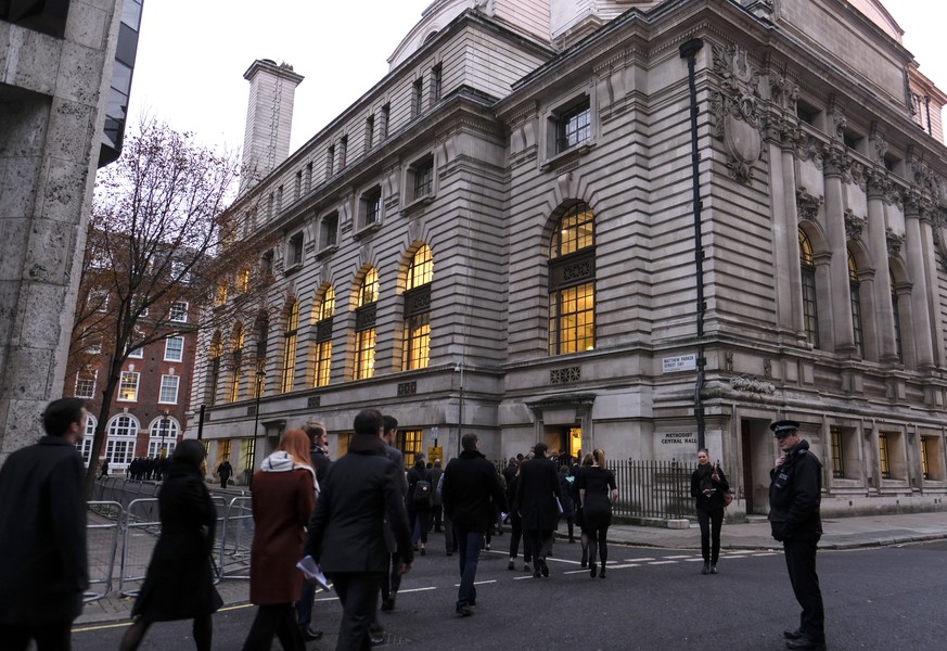 epa08040791 People stand in the street after Central Hall Westminster was evacuated in the early morning hours in London, Britain, 03 December 2019. The venue is set to host the NATO Summit on 03-04 D ...