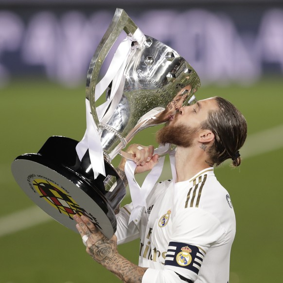 Real Madrid's captain Sergio Ramos kisses the trophy as he celebrates after winning the Spanish La Liga 2019-2020 following a soccer match between Real Madrid and Villareal at the Alfredo di Stef ...