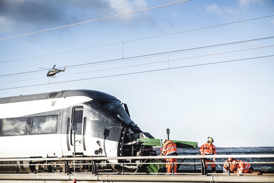 Rescue workers at the site of a train accident on Great Belt Bridge- Storebaeltsbroen, in Nyborg, in Denmark, Wednesday, Jan. 2, 2019. At least six people were killed and 16 others injured early Wedne ...