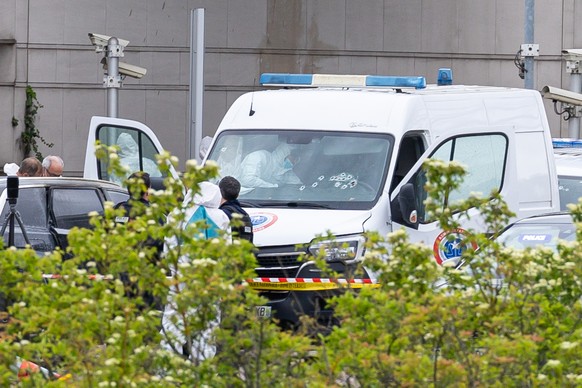 epa11340381 French forensic police inspect a vehicle at the toll station of Incarville, near Rouen, in the North of France, where gunmen ambushed a prison van on 14 May 2024, killing two prison guards ...