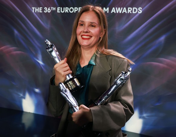 epa11020401 French Director Justine Triet poses with her European Film 2023, European Screenwriter 2023 and European Director 2023 Awards for Anatomy Of A Fall during the 36th European Film Awards in  ...