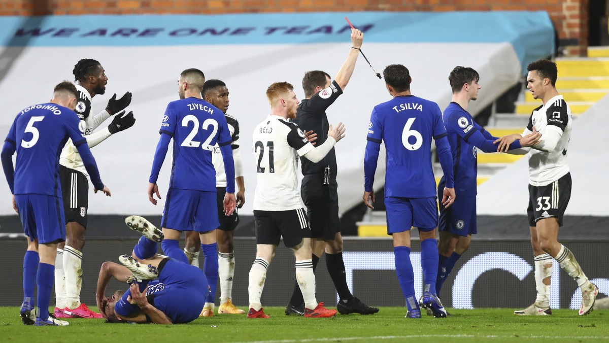 Fulham's Antonee Robinson is shown a red card by referee Peter Bankes during the English Premier League soccer match between Fulham and Chelsea at Craven Cottage in London, England, Saturday, Jan ...