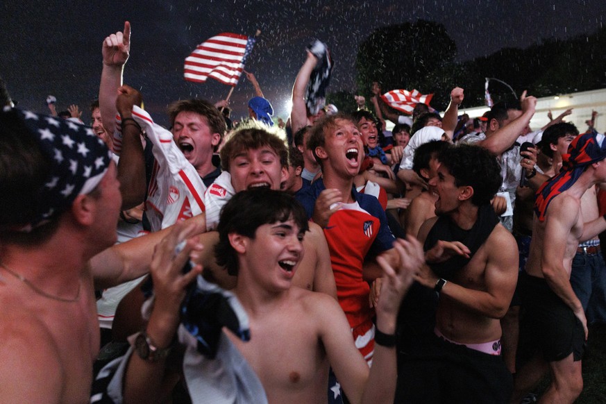 epa13033780 USA fans celebrate as USA scores a goal during the USA vs Paraguay soccer match, at a World Cup 2026 Fan Zone on the National Mall in Washington, DC, USA, 12 June 2026. The FIFA World Cup  ...