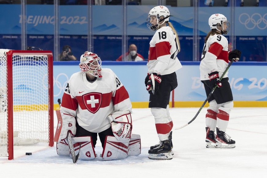 Switzerland&#039;s goaltender Andrea Braendli, left, Switzerland&#039;s defender Stefanie Wetli, center, and Switzerland&#039;s defender Shannon Sigrist, right, react after taking their 6th goal, duri ...