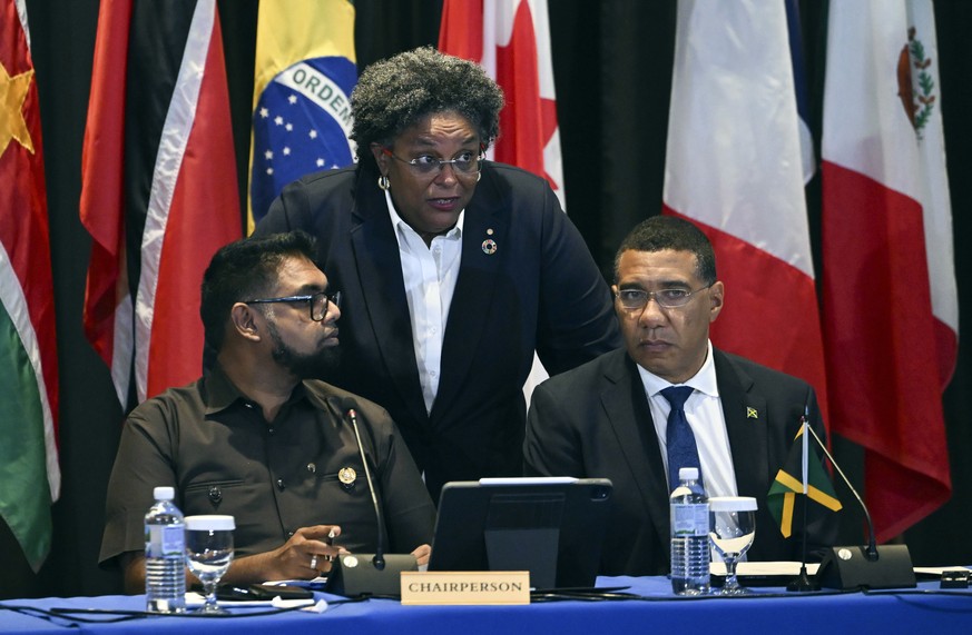 Guyana&#039;s President Irfaan Ali and Jamaica&#039;s Prime Minister Andrew Holness, right, talk with Barbados Prime Minister Mia Mottley as they attend an emergency meeting on Haiti at the Conference ...