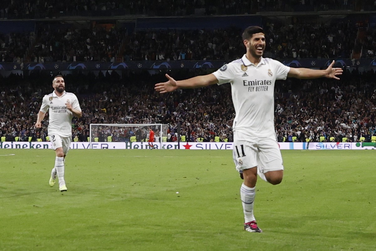 epa10570178 Real Madrid's Marco Asensio (R) celebrates after scoring the 2-0 goal during the UEFA Champions League quarter final first leg soccer match between Real Madrid and Chelsea FC, in Madr ...