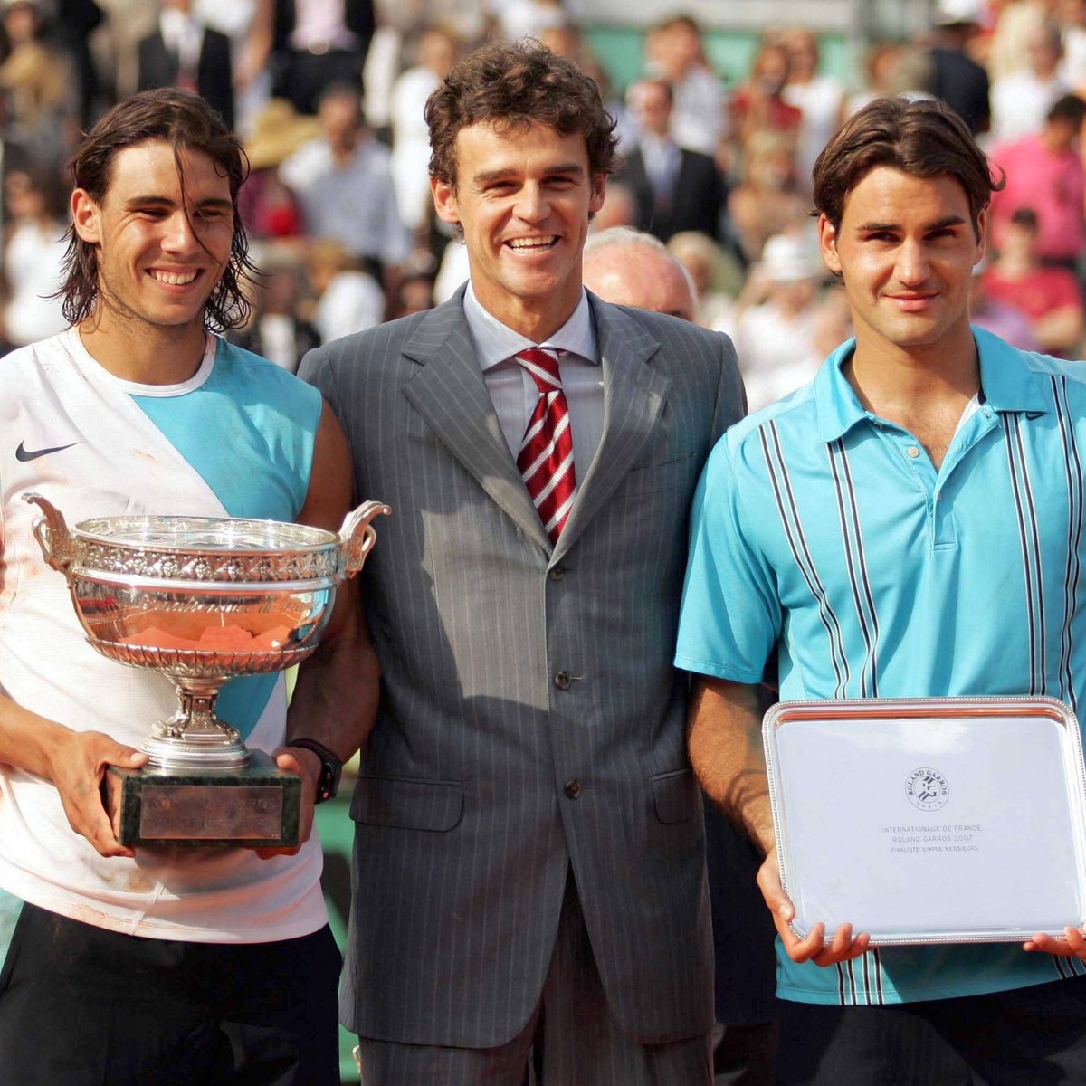- PARIS, FRANCE : Spanish Rafael Nadal (L) celebrates with the cup after winning the men s single final vs Switzerland s Roger Federer (R) at Roland Garros, French Tennis Open tournement, Sunday 10 Ju ...