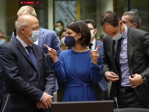 German Foreign Minister Annalena Baerbock, center, speaks with Portugal&#039;s Foreign Minister Augusto Santos Silva, left, and Slovenia&#039;s Foreign Minister Anze Logar, right, during a meeting of  ...