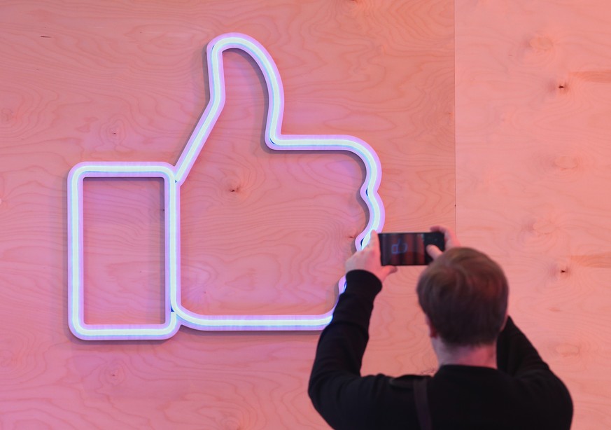 BERLIN, GERMANY - FEBRUARY 24: A visitor snaps a photo of the Facebook &quot;Like&quot; symbol at the Facebook Innovation Hub on February 24, 2016 in Berlin, Germany. The Facebook Innovation Hub is a  ...