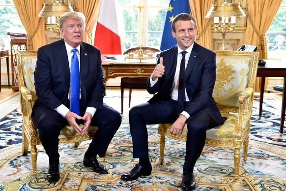 epa06085734 French President Emmanuel Macron (R) gestures during a meeting with US President Donald J. Trump (L) at the Elysee Palace in Paris, France, 13 July 2017, during Trump&#039;s 24-hour trip t ...